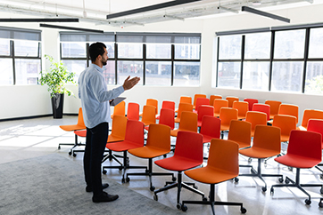Caucasian man training himself in a conference room